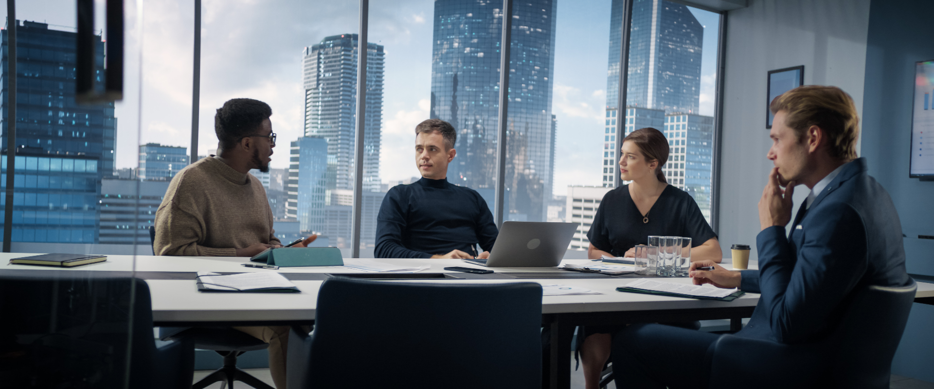 Senior workplace consultants reviewing compliance documents in a modern boardroom