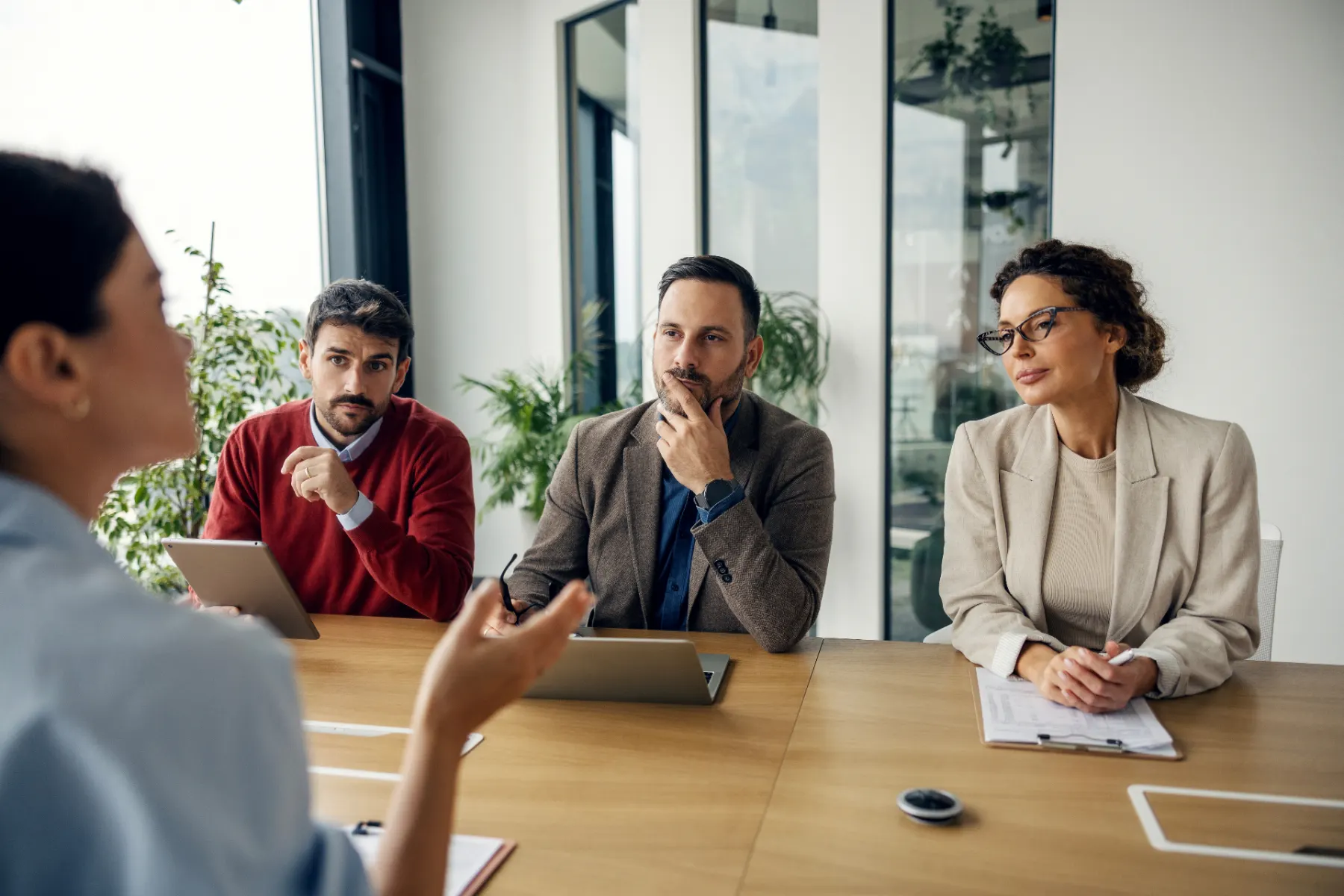 Workplace consultant reviewing employment compliance documents with executives